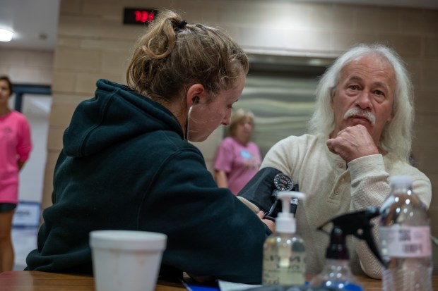 A patient has his blood pressure checked at a mobile dental and medical clinic on October 7, 2023 in Grundy, Virginia. RAM provides free medical care through mobile clinics in underserved, isolated or impoverished communities across the country and the world. As health care continues to be a contentious issue in America, an estimated 29 million Americans, about one in 10, lack insurance coverage. This rate is significantly high in rural and poorer parts of the country. (Photo by Spencer Platt/Getty Images)